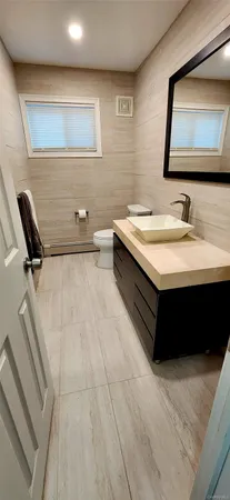 a bathroom with a double vanity sink a mirror and bathtub