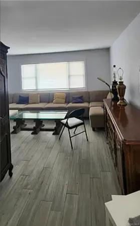 a workspace with wooden floor and windows