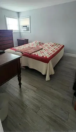 a bedroom with a bed and window