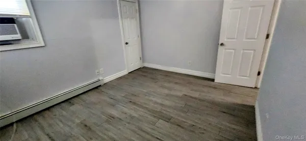 a view of a room with wooden floor