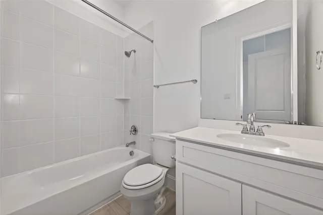 a bathroom with a sink double vanity granite tub shower and a mirror