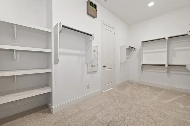 a bedroom with a large bed chandelier and a window