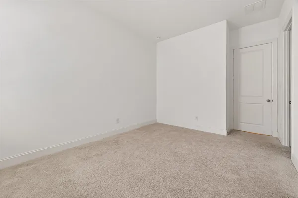 an empty room with an empty space and windows