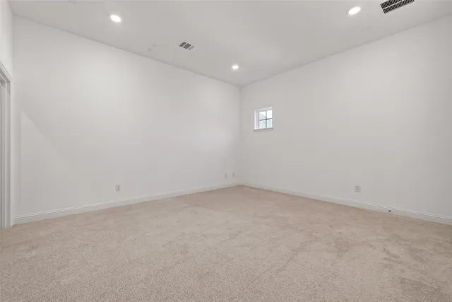 a view of a big house with a big yard and large trees