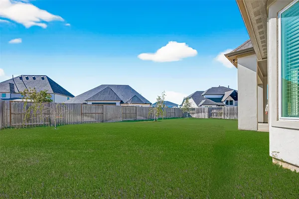 a view of a house with a yard and sitting area