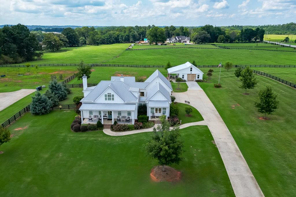 a view of a house with a big yard and potted plants