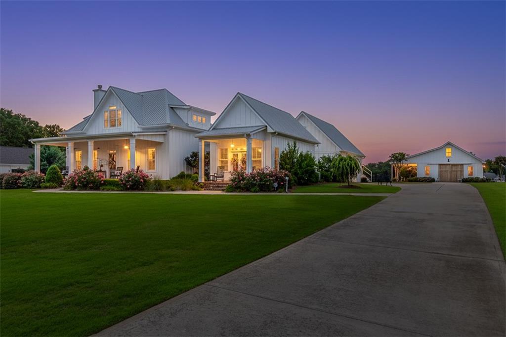 890 Smith Mill Road Winder, GA 30680 - Photo 2 of 95 a front view of a house with a garden and yard