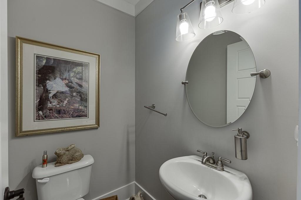 890 Smith Mill Road Winder, GA 30680 - Photo 23 of 95 a bathroom with a toilet a sink and mirror