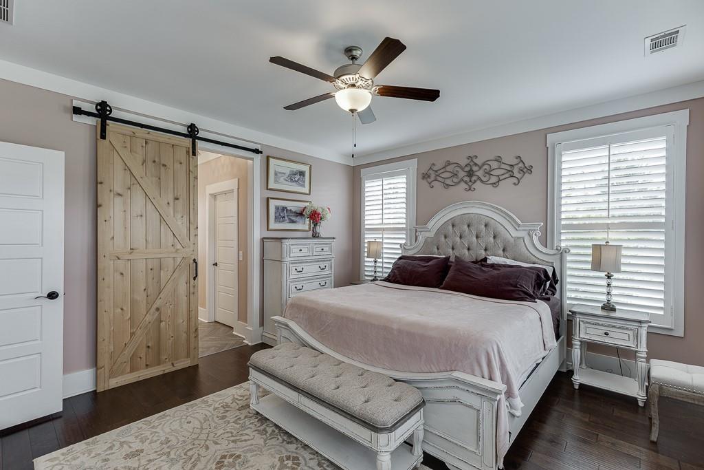 890 Smith Mill Road Winder, GA 30680 - Photo 27 of 95 a bedroom with a large bed and a chandelier