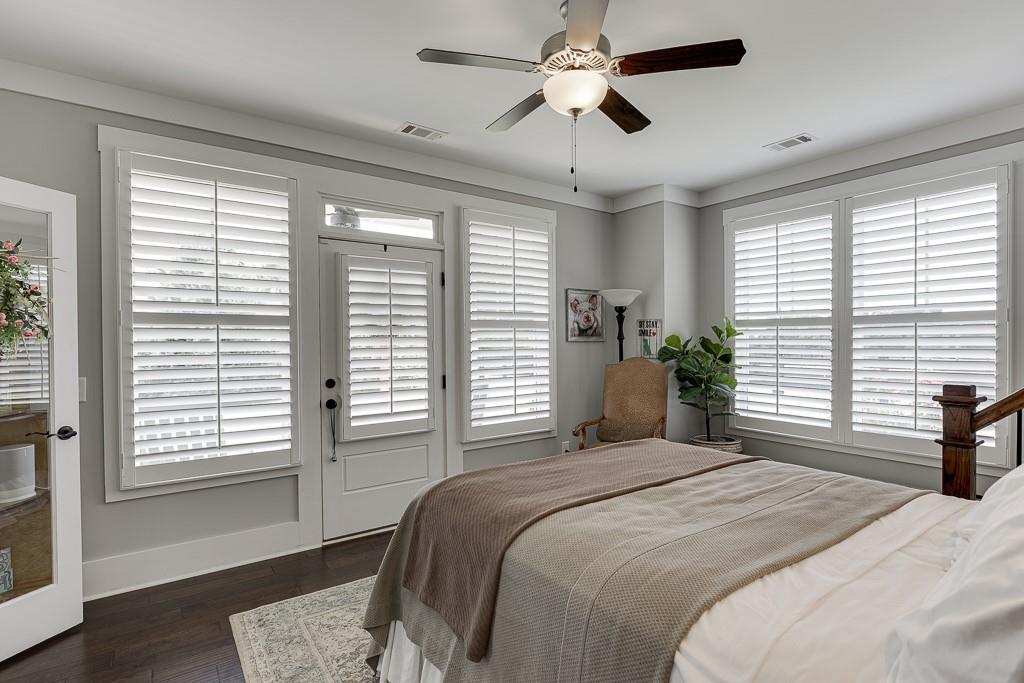 890 Smith Mill Road Winder, GA 30680 - Photo 46 of 95 a bedroom with a large bed and a chandelier