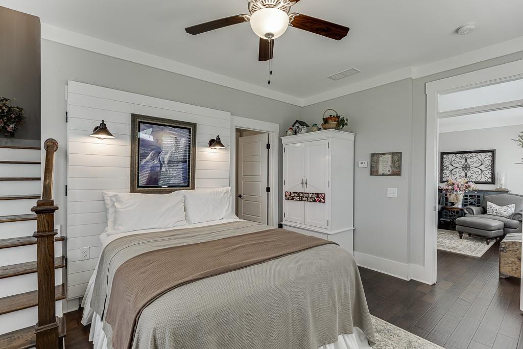 890 Smith Mill Road Winder, GA 30680 - Photo 52 of 95 a bedroom with a large bed and a chandelier