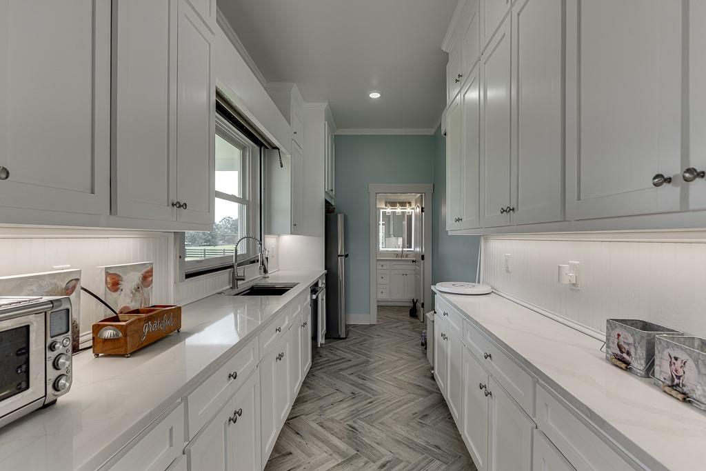 890 Smith Mill Road Winder, GA 30680 - Photo 74 of 95 a kitchen with stainless steel appliances a sink stove and cabinets