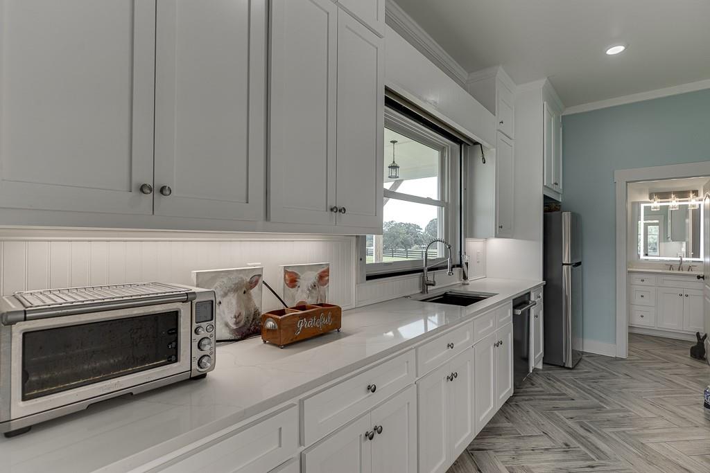 890 Smith Mill Road Winder, GA 30680 - Photo 75 of 95 a kitchen with stainless steel appliances granite countertop white cabinets and window