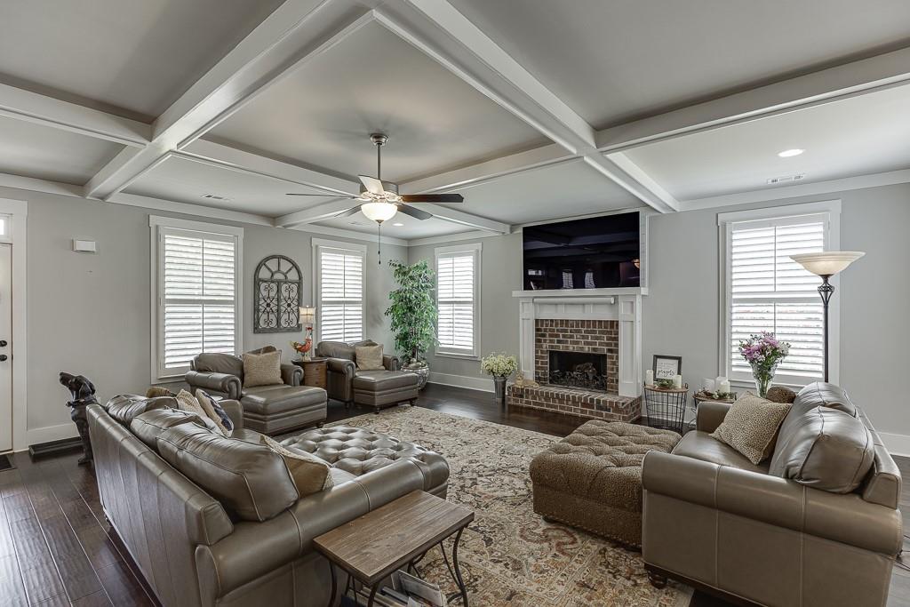 890 Smith Mill Road Winder, GA 30680 - Photo 10 of 95 a living room with furniture a fireplace and a large window
