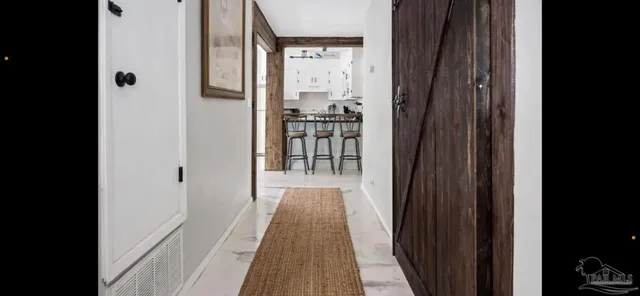 a view of a livingroom with furniture and a ceiling fan