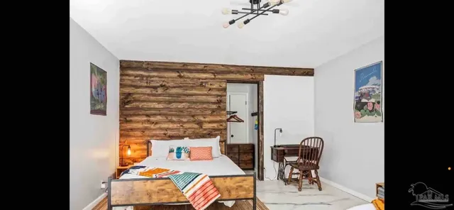 a bed room with a bed and a chair