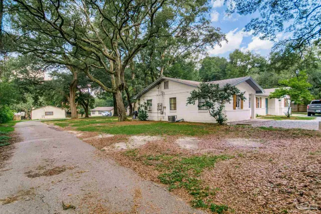 a backyard of a house with table and chairs