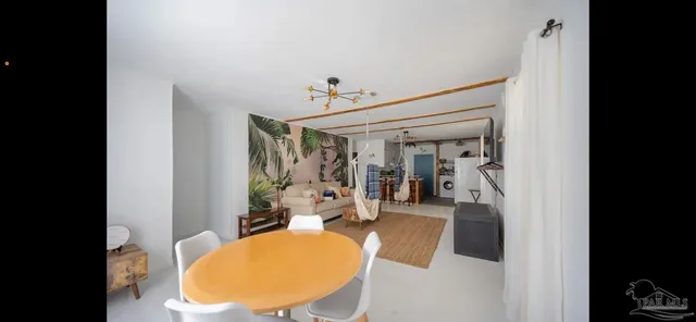 a view of hallway with window and wooden floor
