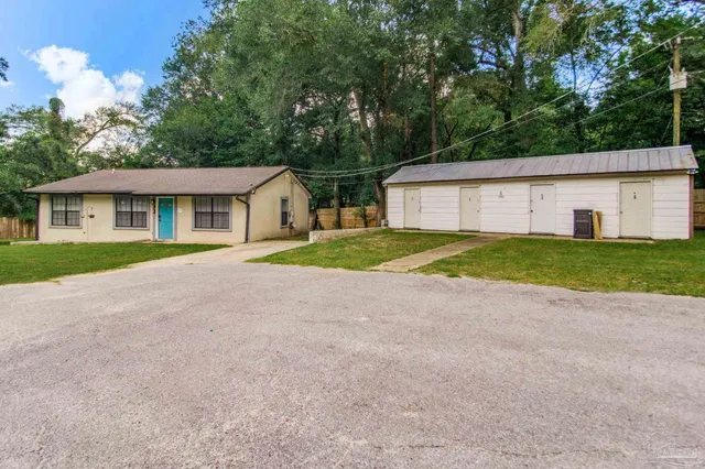 a front view of house with yard and green space