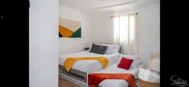 a kitchen with refrigerator and chairs