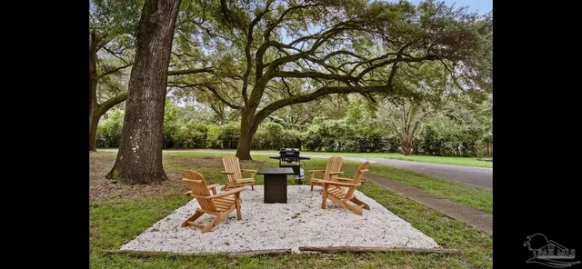 a view of a chair and table in backyard