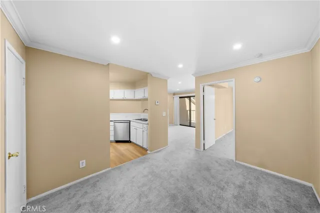 a view of a kitchen with a sink and a refrigerator
