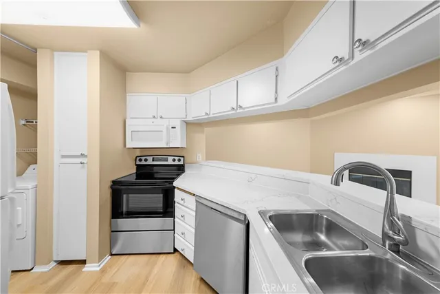 a kitchen that has a sink and a stove