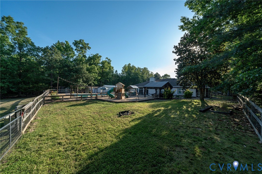 12700 Coalboro Road Chesterfield, VA 23838 - Photo 44 of 50 Spacious fenced yard featuring a wooden play struc