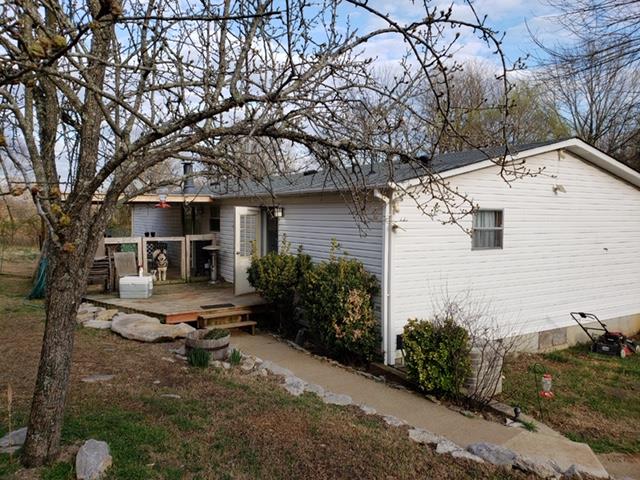 4305 Chicken Road Lebanon, TN 37090 - Photo 15 of 28 a white house that has a tree in front of it