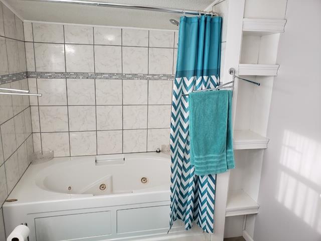 4305 Chicken Road Lebanon, TN 37090 - Photo 10 of 28 a bathroom with a bathtub and a shower