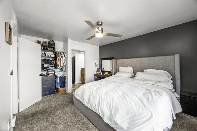 a spacious bedroom with a bed and a walk in closet