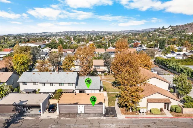 an aerial view of a house with a yard and lake view