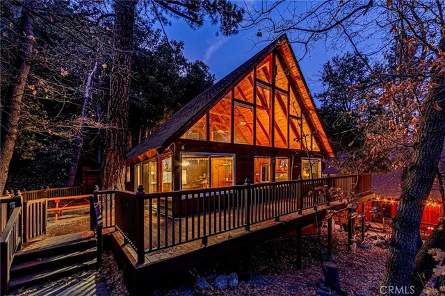 a view of a house with a deck and furniture