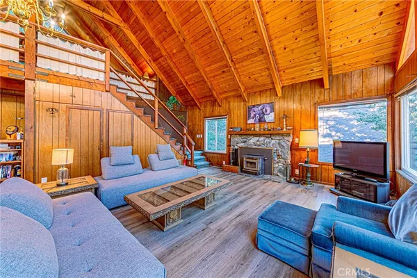 a view of a patio with table and chairs with wooden floor and fence