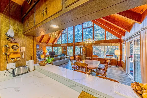 a view of a kitchen with stainless steel appliances granite countertop a sink and wooden floor