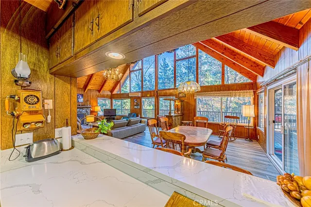 a view of a kitchen with stainless steel appliances granite countertop a sink and wooden floor