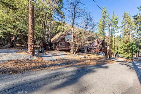 a roof deck with table and chairs under an umbrella