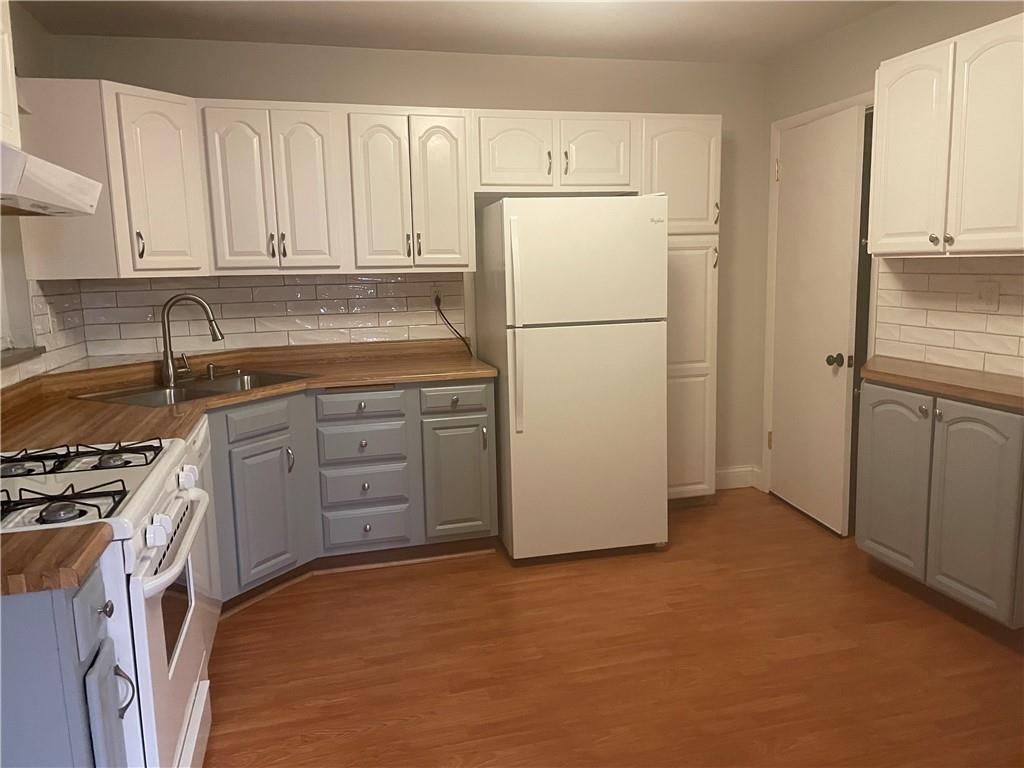 130 Bradys Ridge Road Beaver, PA 15009 - Photo 16 of 22 a kitchen with a refrigerator sink stove and cabinets
