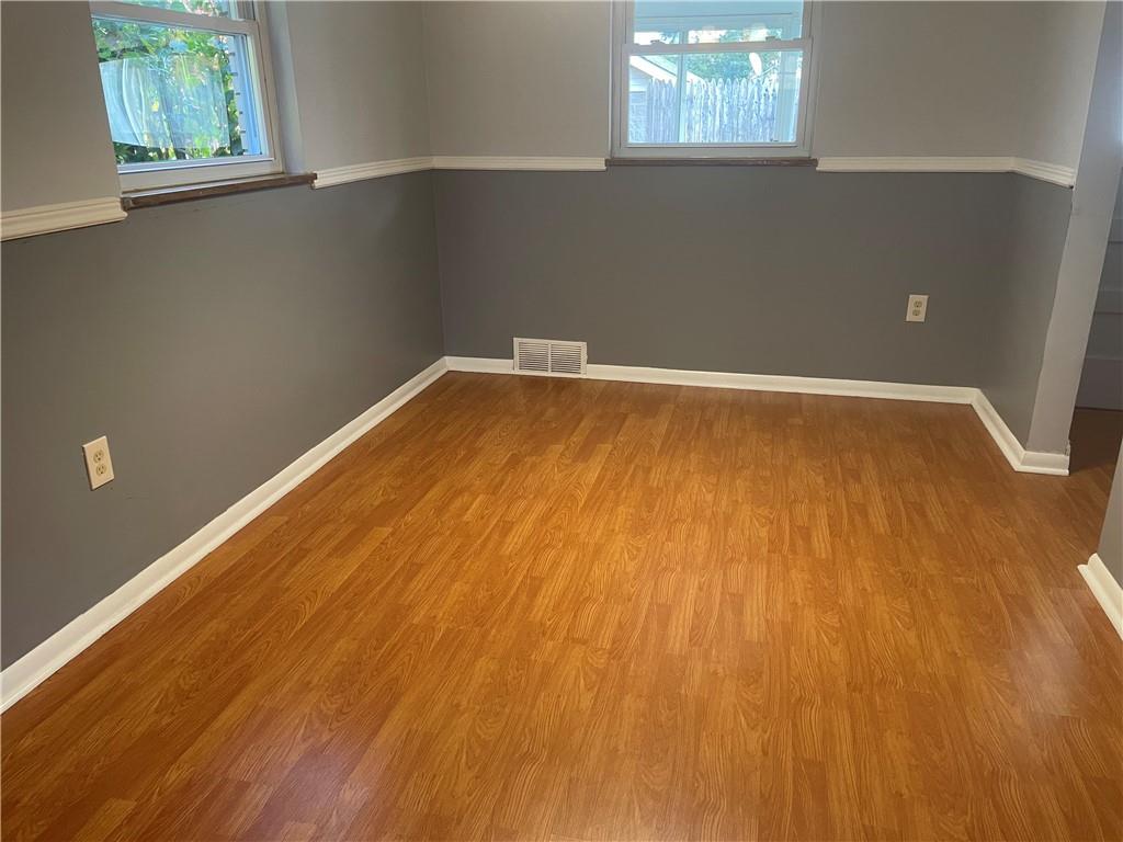 130 Bradys Ridge Road Beaver, PA 15009 - Photo 19 of 22 an empty room with wooden floor and windows