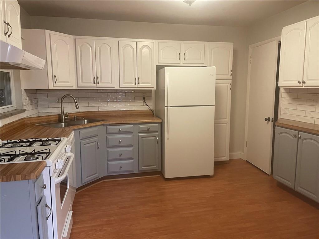 130 Bradys Ridge Road Beaver, PA 15009 - Photo 2 of 22 a kitchen with a refrigerator sink stove and cabinets