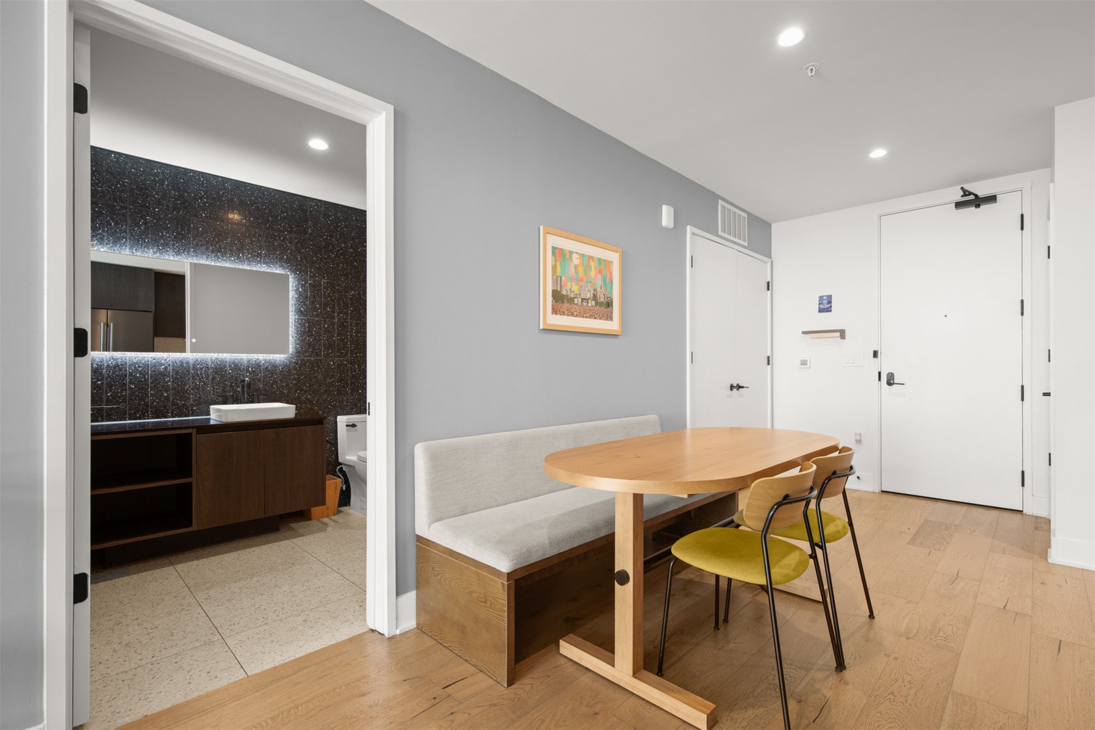 48 East Avenue, Unit 2807 Austin, TX 78701 - Photo 7 of 23 Conveniently positioned, the dining area and kitchen offer easy access to the bathroom, making it effortless for guests to navigate between spaces during meals and gatherings