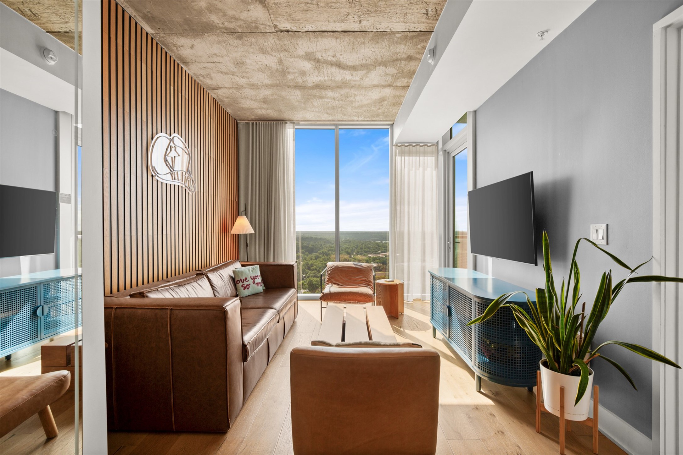48 East Avenue, Unit 2807 Austin, TX 78701 - Photo 9 of 23 The living room is elevated by soaring ceilings, making the space feel expansive and full of possibility