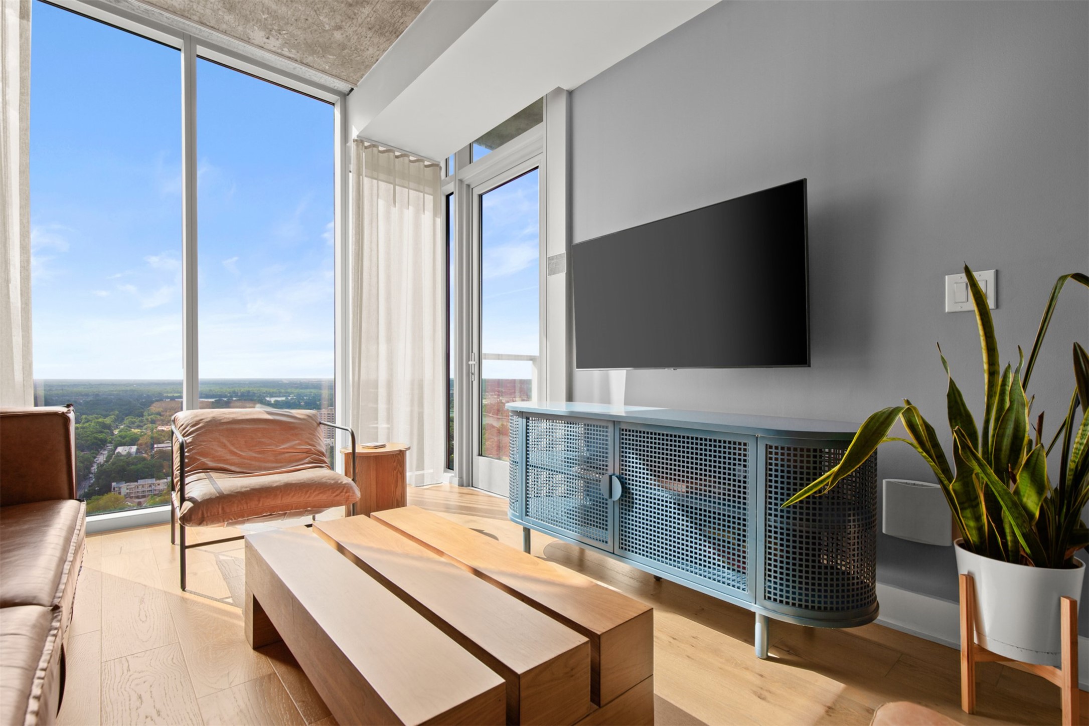 48 East Avenue, Unit 2807 Austin, TX 78701 - Photo 10 of 23 A wall of windows floods the room with natural light, offering a bright, sun-drenched backdrop for every moment
