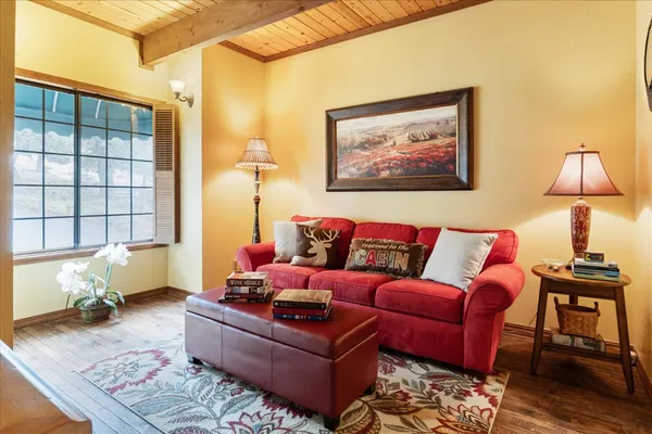 a living room with furniture and a lamp