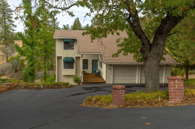 front view of a house with a tree