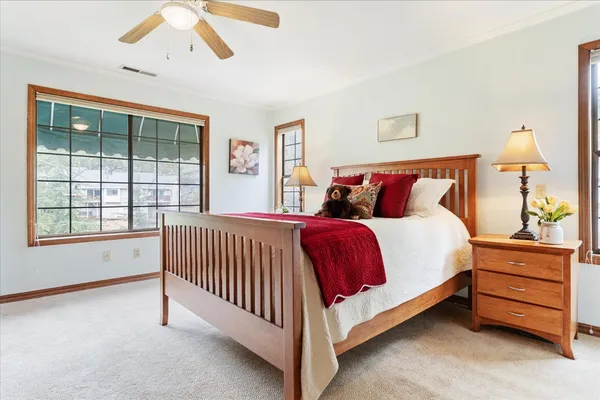 a bedroom with a bed and a chandelier