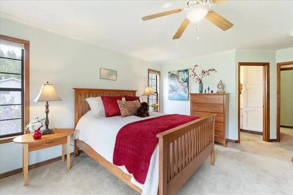 a bathroom with a granite countertop sink mirror vanity and toilet
