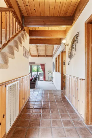 a view of a porch with wooden floor and windows