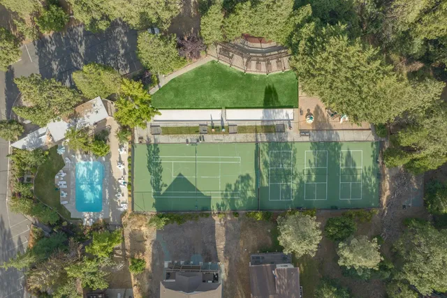 a view of backyard with seating space and trees