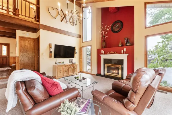 a living room with furniture a flat screen tv and a fireplace